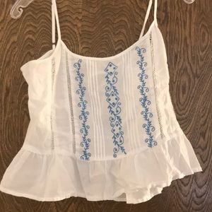 White crop top with blue embroidery detail